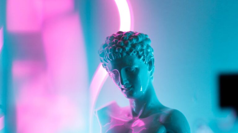 A decorative image of a bust in front of neon lights